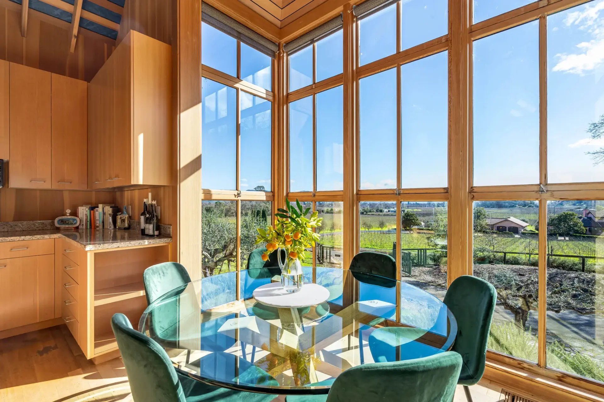 A quiet table inside the Ninth Acre house, the vineyard beyond the windows