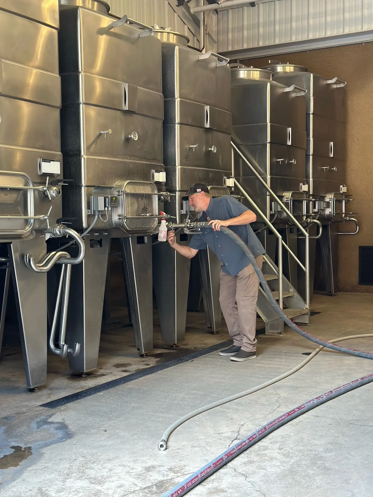 Shawn Johnson at work with the fruit at the fermentation tanks